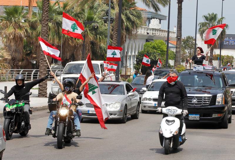 Anti-government demonstrators wave Lebanese flags as they protest in their cars, amid a countrywide lockdown to combat the spread of the coronavirus disease in Beirut, Lebanon. Reuters