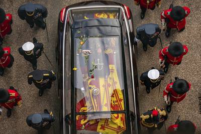 Flowers thrown by the public lie on the hearse carrying the coffin as it arrives at Windsor Castle. AP