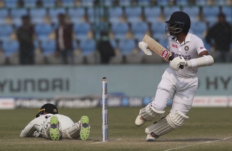 New Zealand wicketkeeper Tom Blundell dives for the ball after India's Wriddhiman Saha plays a shot. AP