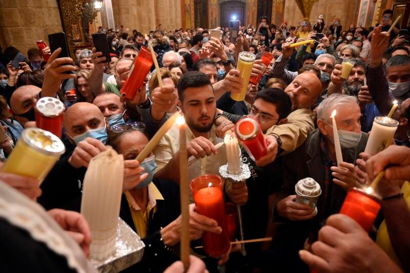 Greek Orthodox Christians light candles with the 'Holy Fire' at St. George Greek Orthodox Cathedral in Beirut, Lebanon. EPA