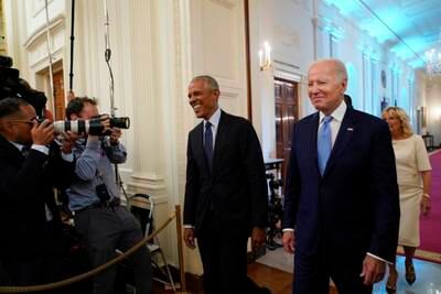 Mr Biden and Mr Obama arrive in the East Room of the White House for the unveiling. AP