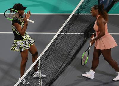 Venus jokes with Serena after clinching her success. AP