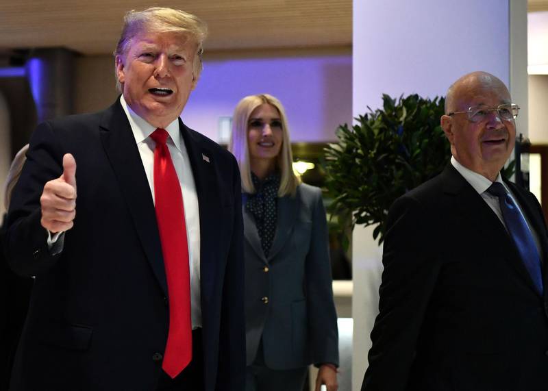 US president Donald Trump gestures flanked by his daughter White House Senior Advisor Ivanka Trump and World Economic Forum (WEF) founder and executive chairman Klaus Schwab,  as they arrive at the Congress center during the World Economic Forum (WEF) annual meeting in Davos. AFP