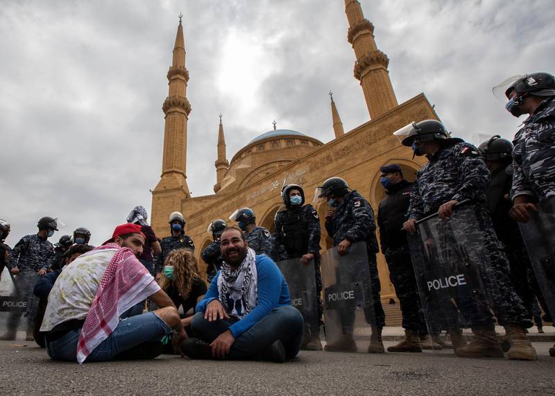 Anti-government protestor shouts slogans in front Lebanese police officers as they try to close the road in front Al-Ameen mosque during a protest against the collapsing Lebanese pound currency and the price hikes of goods, in Beirut, Lebanon.  EPA