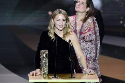 Belgian actress Virginie Efira accepts the Best Director award on behalf of French actor and film director Albert Dupontel for the movie 'Adieu les cons' (Bye Bye Morons) during the 46th edition of the Cesar Film Awards ceremony at The Olympia concert venue in Paris, France. AFP