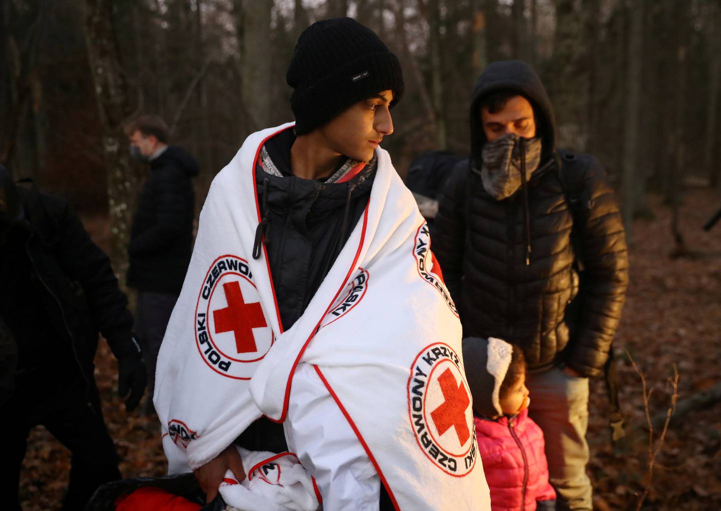 A migrant is wrapped in a Red Cross blanket outside Narewka, Poland. Reuters