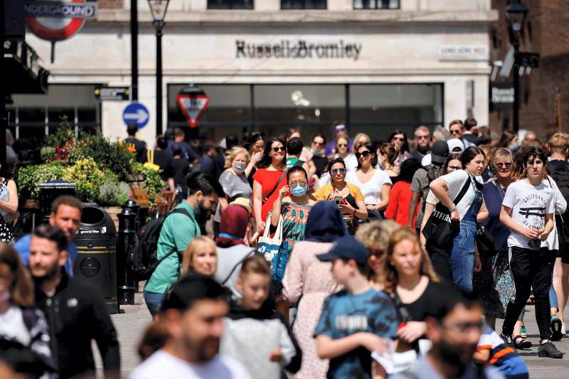 People walk through Covent Garden in central London on June 3, 2021.  The UK government are set to decide on June 14 whether their plan to completely lift coronavirus restrictions will go ahead as scheduled on June 21 amid concern over rising infections.  / AFP / Tolga Akmen
