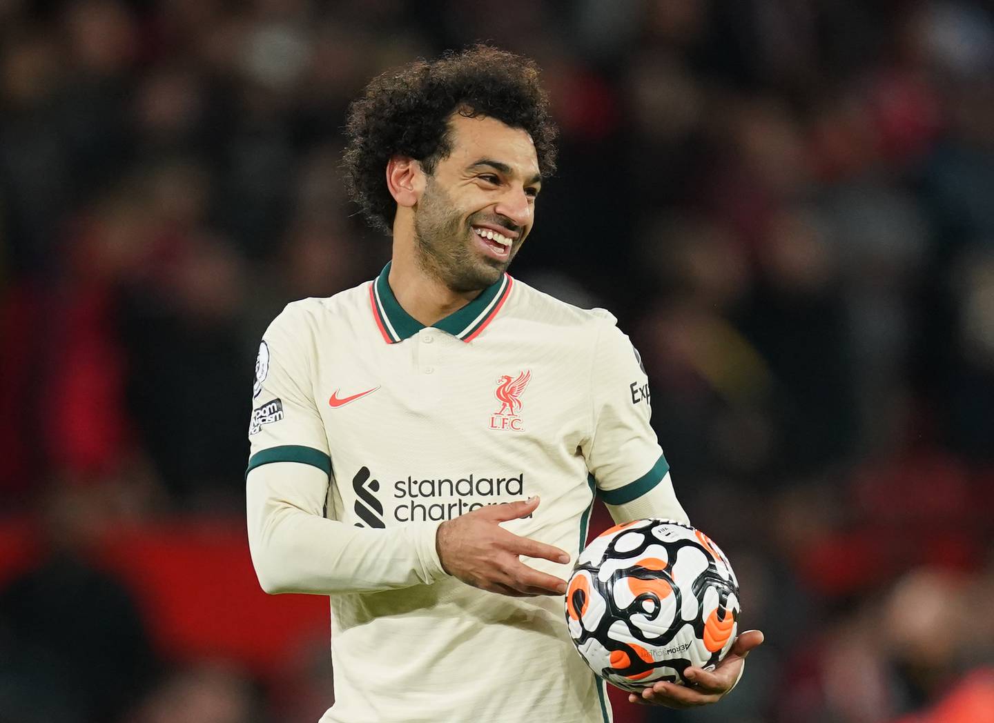 Liverpool hat-trick scorer Mohamed Salah celebrates with the match ball at Old Trafford. PA
