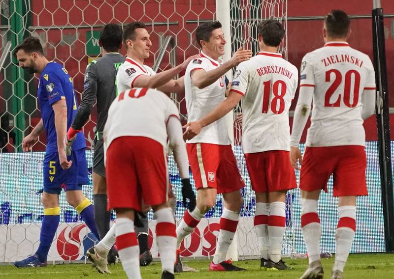 Poland's Robert Lewandowski celebrates with his teammates after scoring the opening goal. AFP
