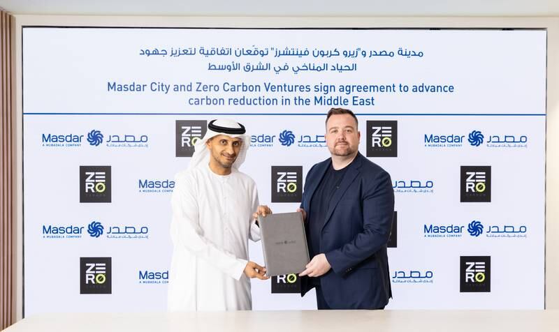 Ahmed Baghoum, executive director, Masdar City, left, signs agreement with Martin Reynolds, chief executive of Zero Carbon Ventures. Photo: Masdar City