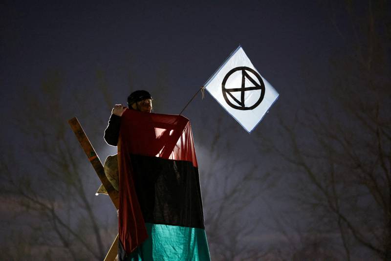 An activist from Extinction Rebellion takes part in an Earth Day demonstration blockading the gate of the New York Times Distribution print facility in Queens, New York City, US. Reuters