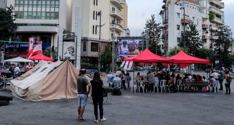 Protesters gather to watch TV in front their tents at the Sasine Square in Achrafieh area  on the tenth day of protest in Beirut, Lebanon.  EPA