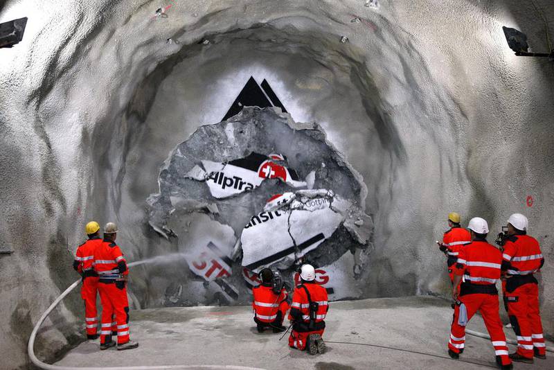 In this June 16, 2009 file photo, workers are seen watching the tunnel drilling machine 'Gabi' breaking through the last section of the New Railway Link through the Alps tunnel between Erstfeld and Amsteg, Switzerland. Sigi Tischler / Keystone via AP