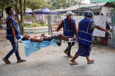 Medical volunteers carry an injured protester who was shot during a demonstration against the military coup in Mandalay. Reuters