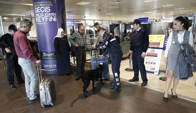 Police with a K-9 dog search luggage at Ataturk airport in Istanbul. Security was tightened across transport links after terrorists carried out attacks at Brussels airport and the metro system. Sedat Una / EPA