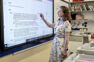 Physics teacher Regina O'Dwyer demonstrates how Dubai College's remote learning system works. Victor Besa / The National