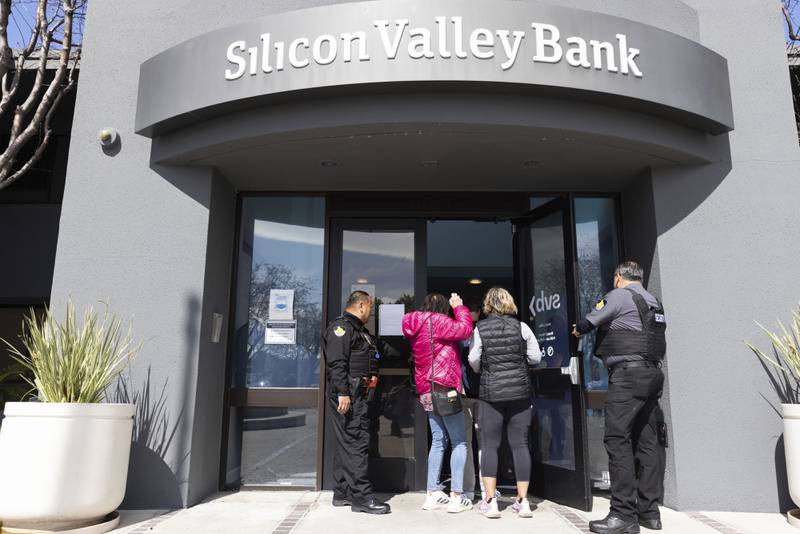 Security guards let people into the Silicon Valley Bank's headquarters in Santa Clara, California, on March 13. AP