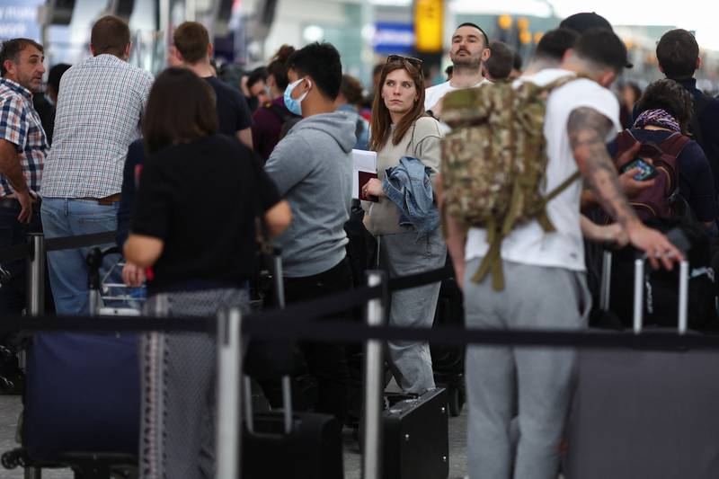 Passengers queue for airport check-in on Thursday afternoon, ahead of the Easter Bank Holiday weekend, at Heathrow Airport. Reuters