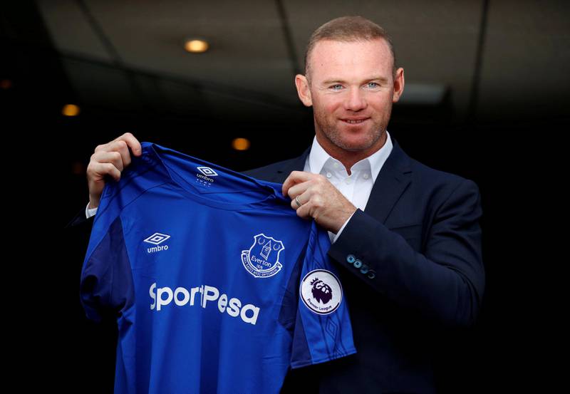 Everton's Wayne Rooney poses with the club shirt after the press conference.