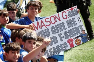 A Getafe fan holds up a sign asking for Mason Greenwood's shirt during a training session at Estadio Coliseum Alfonso Perez. PA