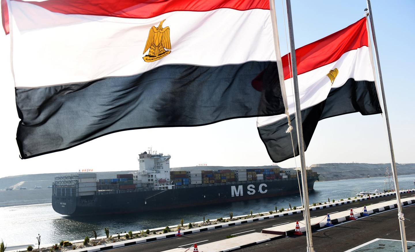 A cargo ship crosses a new waterway at the Suez Canal during its opening ceremony on August 6, 2015, in the port city of Ismailiya. Egyptian President Abdel Fattah al-Sisi staged a lavish ceremony to unveil a "new" Suez Canal, seeking to boost the country's economy and international standing by expanding the vital waterway.  AFP PHOTO / MOHAMED EL-SHAHED (Photo by MOHAMED EL-SHAHED / AFP)