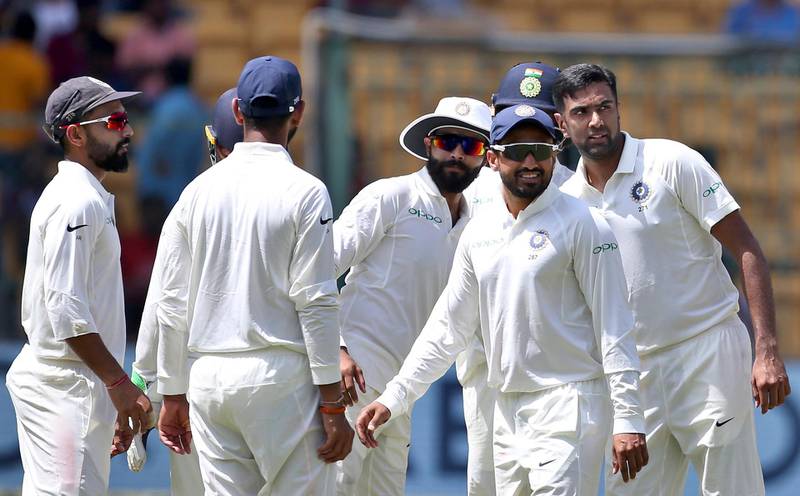 India's Ravichandran Ashwin, right, celebrates with teammates the dismissal of Afghanistan's Yamin Ahmadzai during the second day of their one-off cricket test match in Bangalore, India, Friday, June 15, 2018. (AP Photo/Aijaz Rahi)