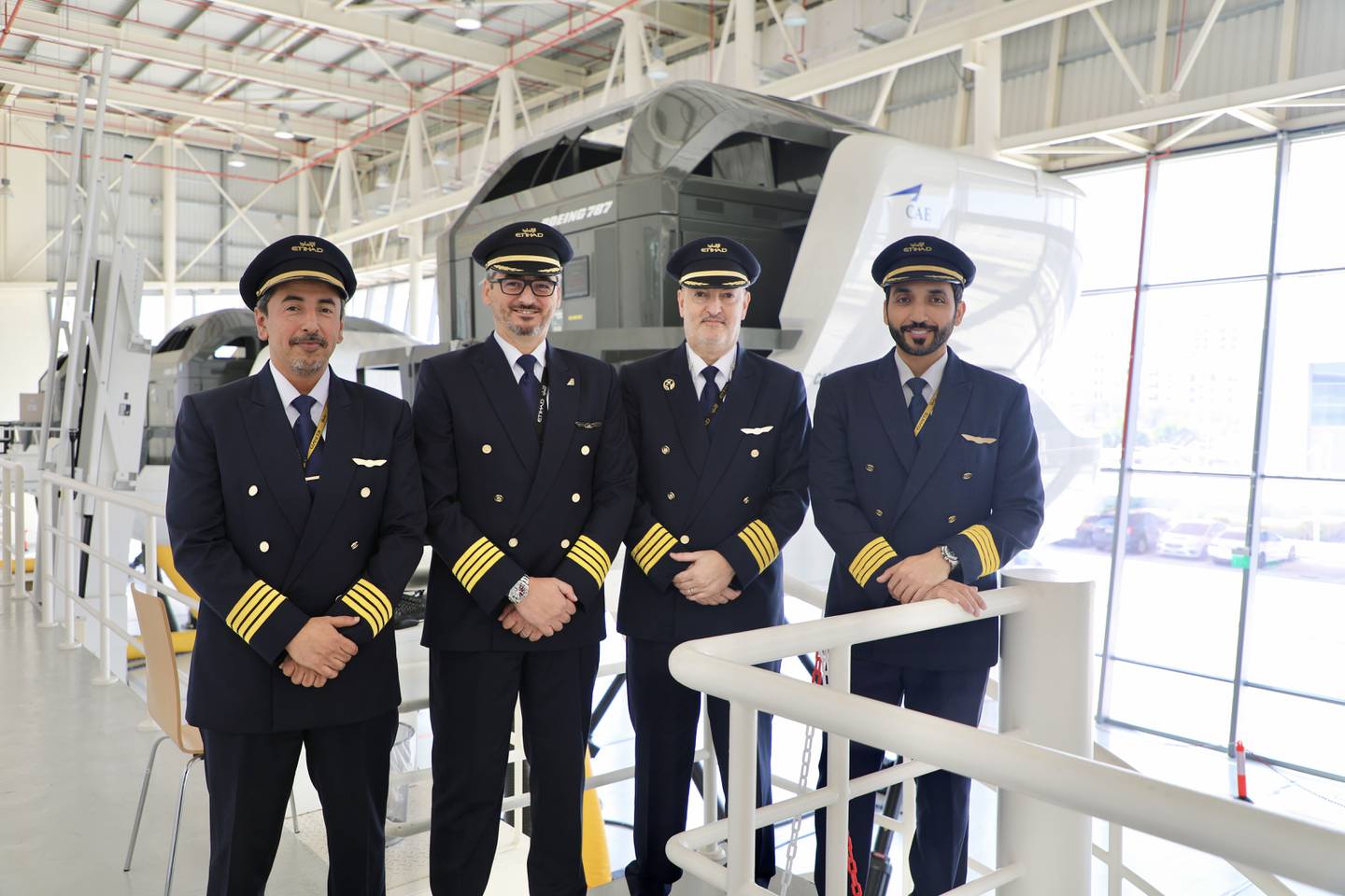 From left to right: Etihad Airways captains Abdulla Saleh, Mimmo Catalano, Driss Moussaoui and Mohammed Al Tamimi in front of a Boeing 787 simulator. Nilanjana Gupta / The National