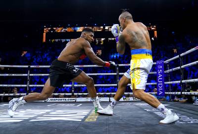 Anthony Joshua and Oleksandr Usyk in action at the King Abdullah Sport City Stadium in Jeddah. PA