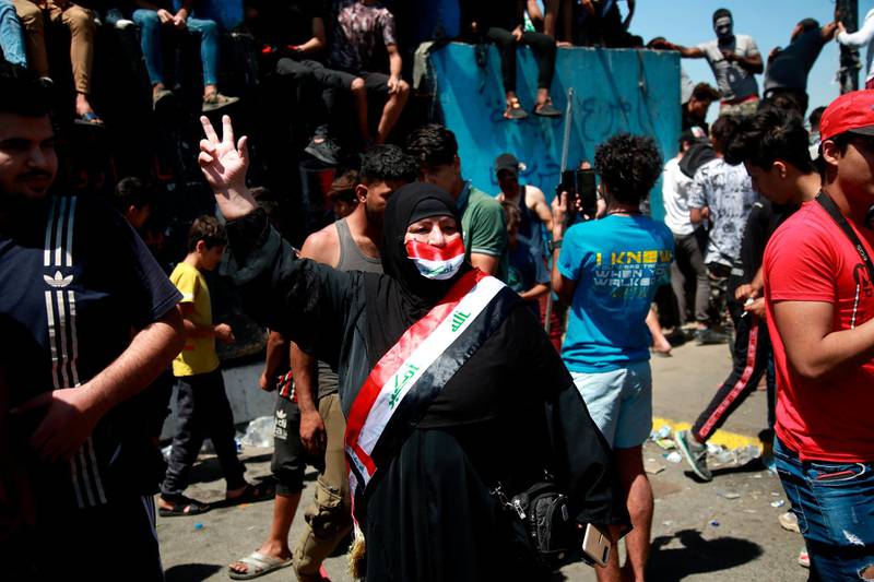 A woman flashes the victory sign during ongoing Anti-government protests in Baghdad, Iraq, Sunday, May. 10, 2020. Protesters were back on the streets three days after Mustafa al-Kadhimi was appointed as Iraq's new prime minister. (AP Photo/Khalid Mohammed)