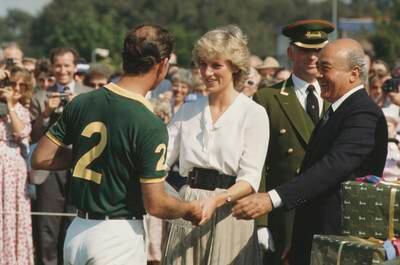 Princess Diana and Mr Al-Fayed present a prize to Prince Charles – now King Charles III – during the Harrods Polo Cup tournament in Windsor in 1987. Getty Images