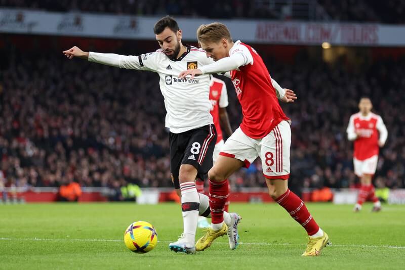 Bruno Fernandes battles for possession with Martin Odegaard of Arsenal. Getty