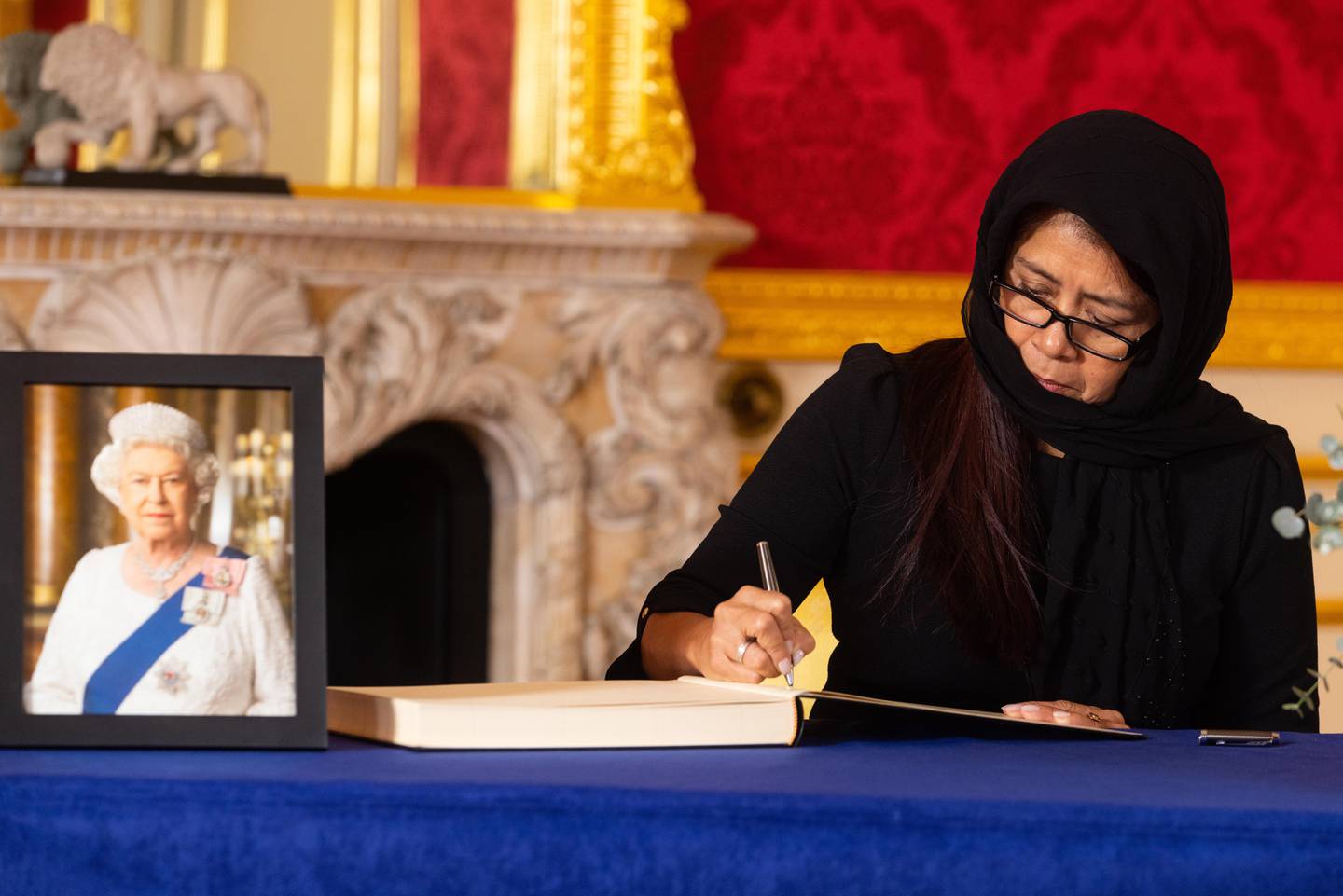 Governor-General of Belize Dame Froyla Tzalam signs a book of condolence at Lancaster House in London following the death of Queen Elizabeth. PA