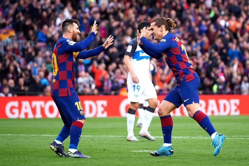 Antoine Griezmann celebrates with Lionel Messi after scoring the opening goal. Getty