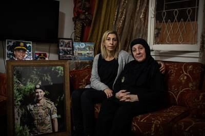 Tharwat and Nada Noureddine sit in their living groom in Mar Elias in Beirut surrounded by photographs of Tharwat’s brother and Nada’s son, Ayman.