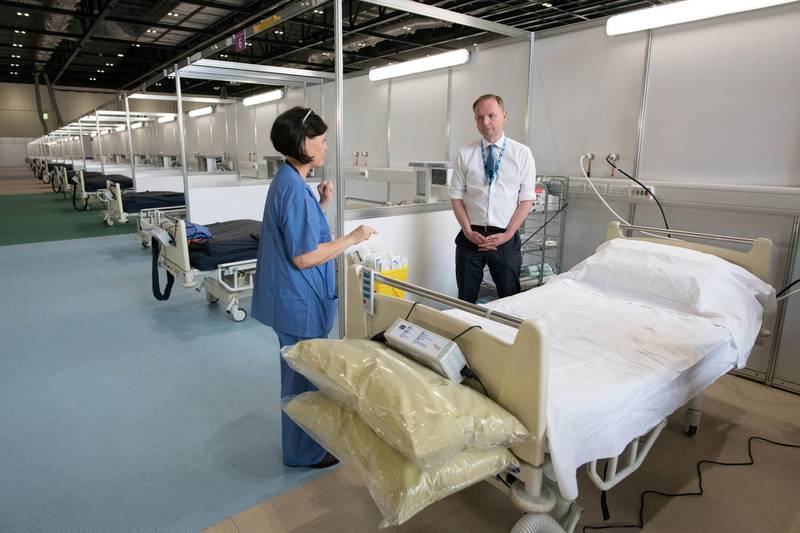 NHS England's Chief Executive Simon Stevens speaks with NHS staff at ExCel London, during its conversion into the temporary NHS Nightingale Hospital, comprising of two wards, each of 2,000 people, to help tackle the coronavirus outbreak, in Newham, London. REUTERS
