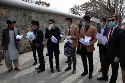 Civil society activists wearing face masks prepare for a campaign to raise awareness of the new coronavirus in Kabul, Afghanistan. AP Photo