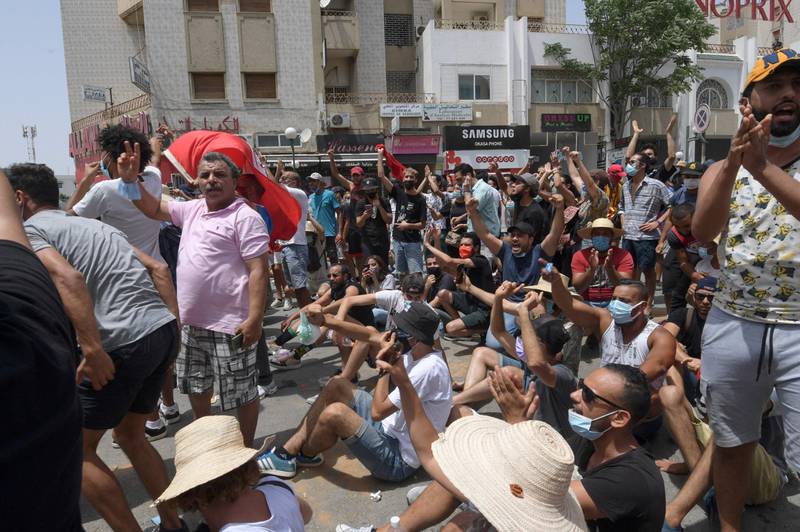 Tunisian anti-government protesters chant slogans as they rally in front of the Parliament in the capital Tunis.