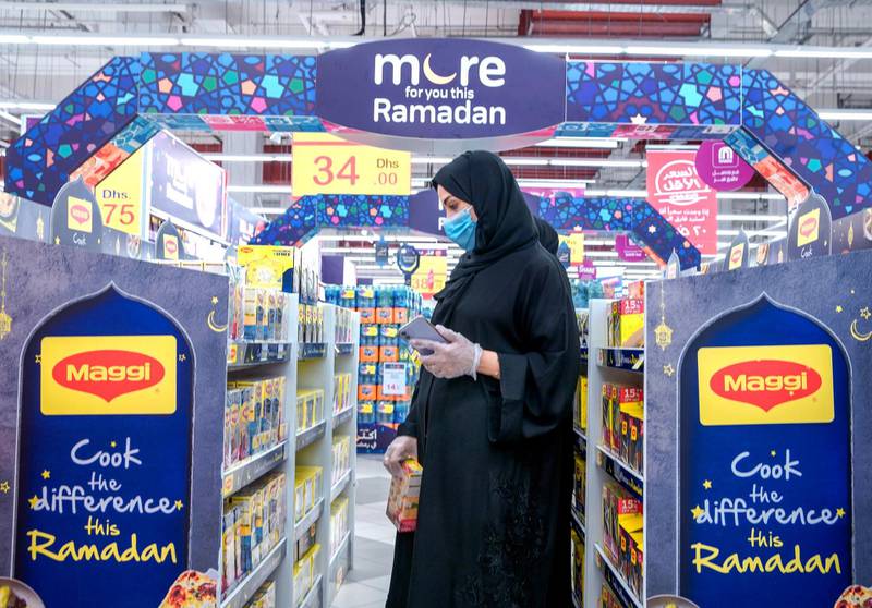 Abu Dhabi, United Arab Emirates, April 21, 2020.   Early Ramadan shoppers at Carrefour Yas Mall.  A lady checks out a Ramadan promotional stand. Victor Besa / The NationalSection:  NAFor:  Stock images