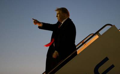 Donald Trump greets supporters as he disembarks Air Force One after landing at El Paso International Airport. Reuters