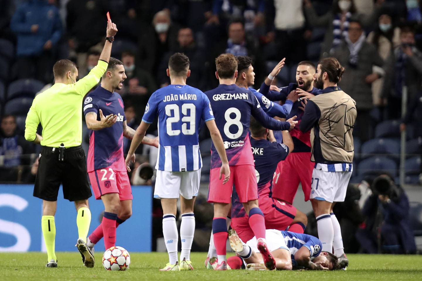 Referee Clement Turpin shows a red card to Atletico Madrid's Yannick Carrasco, second right, during the Champions League group match against Porto last season. AP