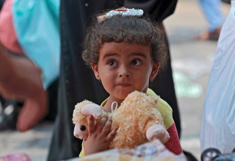A Palestinian girl selects a stuffed toy from a shop at a market in Khan Yunis, in the southern Gaza Strip. AFP