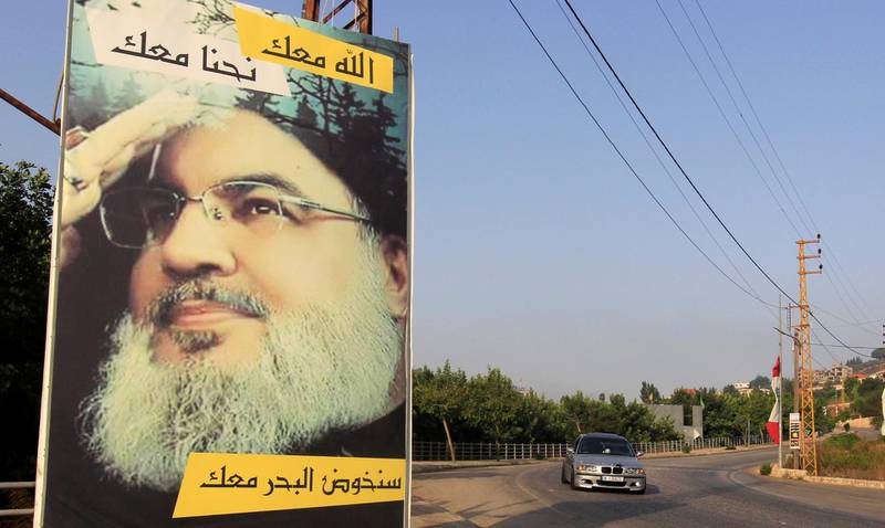A car drives past a poster depicting Lebanon's Hezbollah leader Sayyed Hassan Nasrallah in Adaisseh village, near the Lebanese-Israeli border, Lebanon July 28, 2020. REUTERS/Aziz Taher