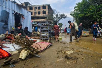 People go around a market area after a flash-flood in Charikar, Parwan province.  AFP