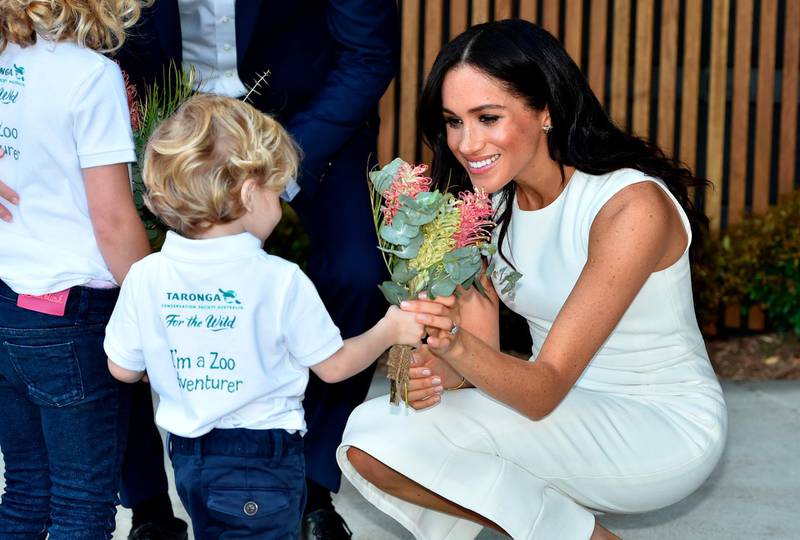Meghan receives native flowers from 4-year-old Findlay Blue after she and Prince Harry officially opened the Taronga Institute of Science and Learning at Taronga Zoo in Sydney. AP Photo