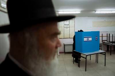 An Ultra-Orthodox Jewish man votes in Israel's parliamentary election at a polling station in Bnei Brak. AP