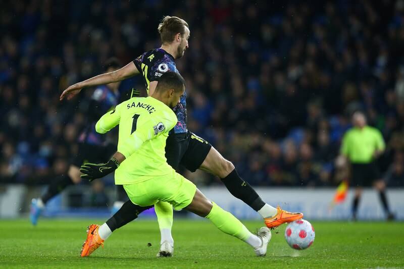Spurs attacker Harry Kane tackles Brighton goalkeeeper Robert Sanchez before missing an early chance. Getty