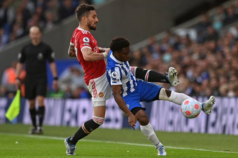 Manchester United's defender Alex Telles vies for the ball with Brighton's midfielder Tariq Lamptey. AFP
