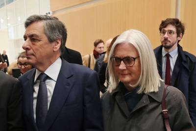 France's former Prime Minister Francois Fillon, left, and his wife Penelope, arrive at the Paris courthouse, in Paris on February 26. AP