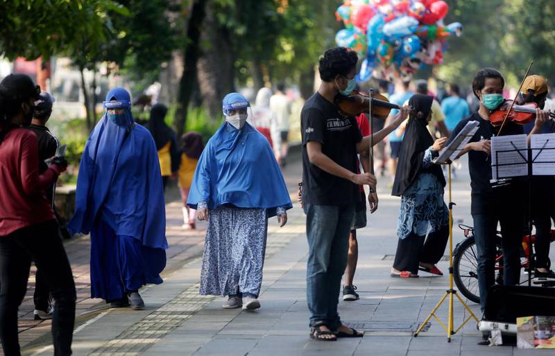 Two Muslim women wear face masks near the Bogor Palace in Bogor, Indonesia.  EPA