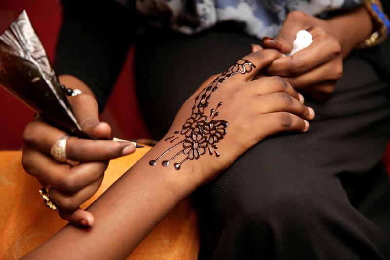A Sudanese woman gets a henna tattoo in Cairo, Egypt, May 29, 2019. Picture taken May 29, 2019. REUTERS/Hayam Adel